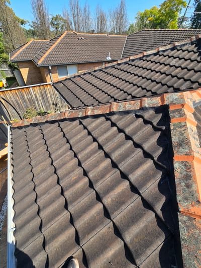New Colorbond metal sheets being installed on a Sydney home with old tiles stripped off
